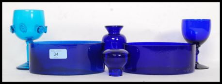 A collection of blue glass items to include handmade examples and Bristol Blue