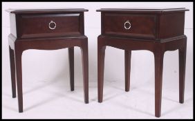 Pair of mahogany Stag ' Minstrel ' bedside tables / cabinets having tapered legs with shaped aprons
