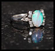 An 18ct gold, opal and diamond ladies ring.