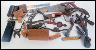A collection of vintage wood working hand tools to include saw,