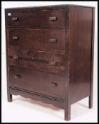 A mid 20th century utility style straight four chest of drawers having a bank of drawers on squared