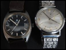 A vintage gentlemans Roamer wristwatch black face searock automatic being set on leather strap.