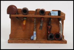 A believed Peter ' Rabbitman ' Heap carved oak pipe rack, with carved rabbit to centre top,