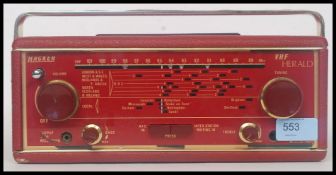 A vintage Hacker Herald red vinyl radio.