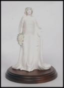 An original Coalport Compton & Woodhouse Limited Edition Queen Elizabeth figurine.