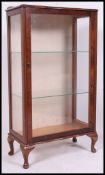 A 1930's oak single china Queen Anne revival display cabinet raised on cabriole legs with pad feet.