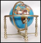 A hardstone A Lapis Lazuli inlaid brass desk top / library revolving globe in gimballed brass frame.