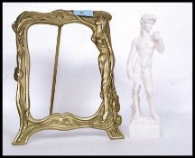 A pair of Parienne style classical figures along with a brass Art Nouveau easel picture frame.