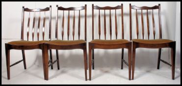 A set of 20th century Stag mahogany dining chairs raised on squared supports with drop in