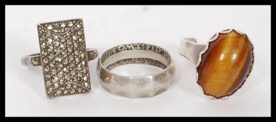 A collection of 3 silver rings.