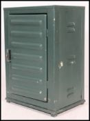 A retro mid century Industrial metal locker cabinet with shaped sides and base having vented full