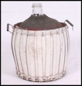 A vintage glass carbouy with wooden coopering to sides.