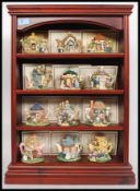 A collection of 12x Minerva Collection ceramic model cottage teapots,