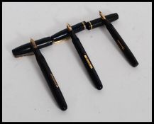 A vintage Watermans 14ct gold nib fountain pen in blue with gold trim together with a Conway