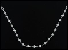 A 14ct white gold and white sapphire set necklance. The white sapphires being set within 14ct gold.