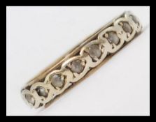 A 9ct gold and stone set eternity ring. Inset stones approx 20 x 1pnts. Total weight 2.2g.