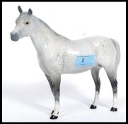 A Beswick ceramic figurine of a grey dappled horse being marked Beswick England in circle motif to