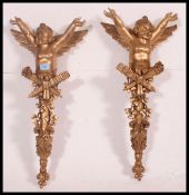 A pair of 20th century  gilt wall hanging winged cherubs in the Baroque style