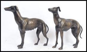 A pair of cast metal bronze effect statues of greyhound racing dogs - each unmarked, no makers name.