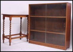 A 1930's oak barleytwist oak side - lamp table together with a similar oak sliding glass library