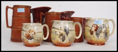 A collection of graduating jugs by British Anchor each with dog - hunting scenes.