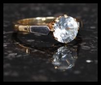 An early 20th century 9ct gold and platinum ring with large cushion cut white sapphire ? stone