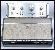 A vintage two tone portable Bush record player with hinged top and inset Monarch deck.