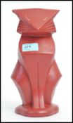 An art deco style cast metal doorstop in the form of a cat.