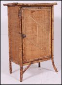 A 19th century aesthetic movement bamboo cabinet having full length door with shelved interior.