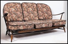A 1970's retro Ercol beech and elm Windsor pattern 3 seat sofa settee couch.