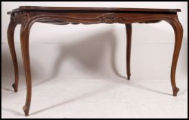 A French 20th century style walnut inlaid extending dining table.