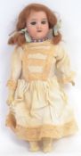 DEP DOLL; An antique 19th century bisque headed German made doll with composition arms and legs.