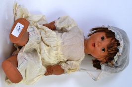 DOLL; A large vintage composition headed and bodied doll with original clothing.