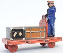 HUKI DGRM LUGGAGE PORTER TINPLATE: A rare Huki HKN DGRM tinplate toy of a luggage porter trolley -