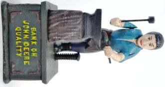 MONEY BOX: A vintage style reproduction cast iron John Deere blacksmith novelty moneybox,