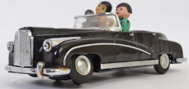 TINPLATE: A vintage Hong Kong tinplate ' Photographer In Car ' battery operated toy model car.