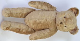 TEDDY BEAR: A large 20th century c1950's straw stuffed bear, with squeaker.