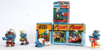 SMURFS: A collection of 9x original vintage Peyo / Schleich Smurfs - 4x being within the original