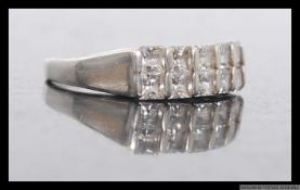A ladies silver 925 pave set CZ square cut dress ring being claw mounted. Size N.5. 3.
