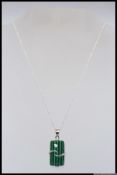A 925 silver pendant neklace with a large malachite style pendant encapsulated by a crucifix silver