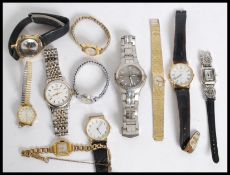 A collection of watches to include a vintage Timex wristwatch with black face and date aperture.