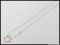 A contemporary ladies silver heart pendant and fine linked silver necklace chain. Total weight 5.