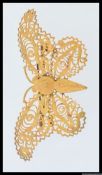A large vintage yellow metal filigree buterfly brooch. Measures 8cms x 4cms. Weight 7.
