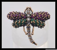 A 925 silver designer ring with stylised Art Nouveau dragonfly encrusted with red,