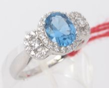 A ladies 925 silver cz stone and blue topaz 3 stone dress / cocktail ring. Total weight 4.2g Size R.