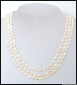 A contemporary 3 string cultured pearl necklace with white metal clasp