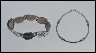 A vintage Siam silver Niello 8 link bracelet marked Siam Silver together with a turquoise and white