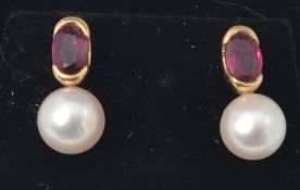 A pair of yellow gold ruby and pearl earrings.