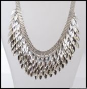 A vintage white metal choker necklace with mesh collar with stylised droplets.
