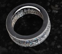 A contemporary ladies silver and baguette cut cz full eternity ring. Total weight 6.